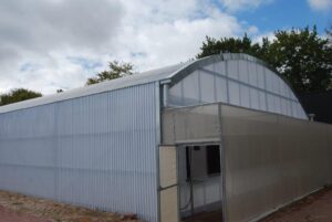 10m x 30m polcarb greenhouse with av net over wet wall